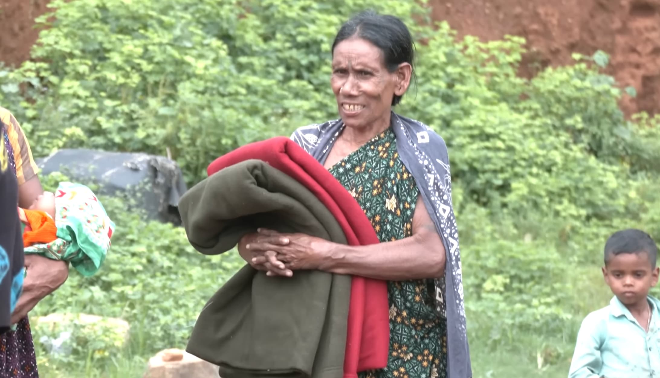 Volunteers distributing rugs to tribal households